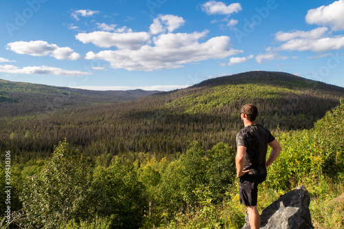 Back view of a hiker admiring the view in the Gaspesia national park  Canada