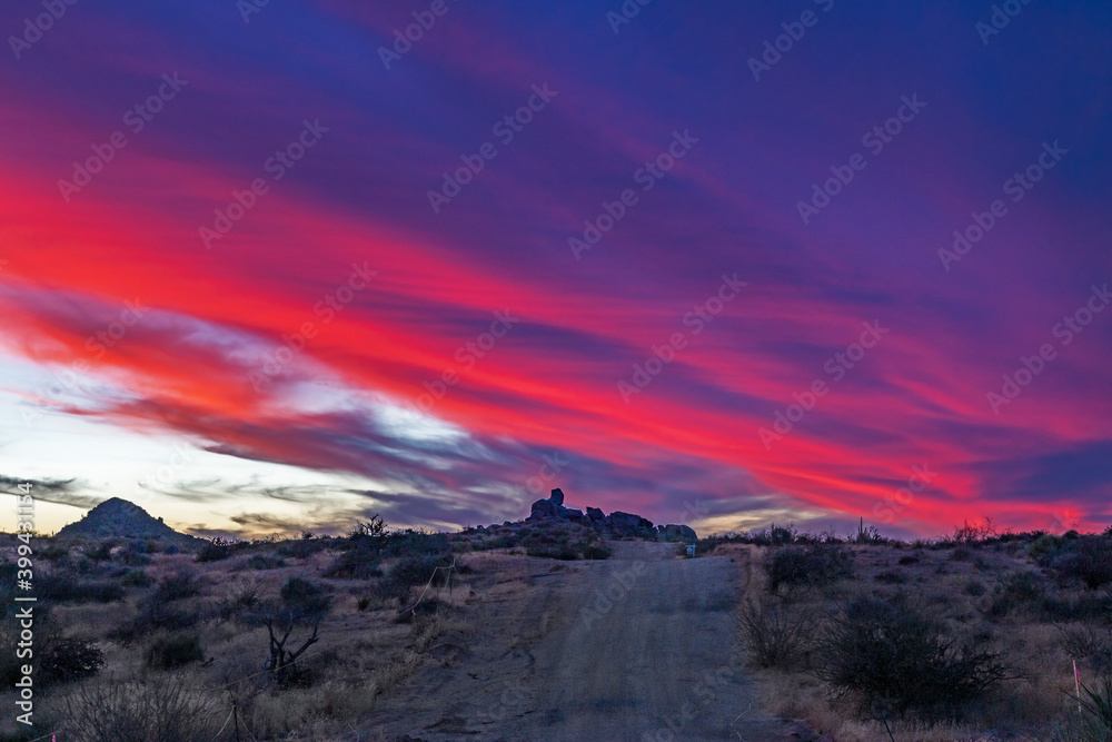 Dirt Road Leading To Vibrant Sunset Skies & Clouds In Arizona