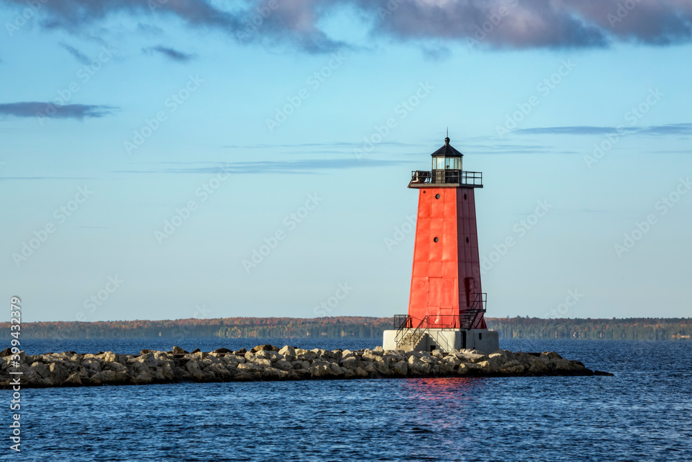 The historic red lighthouse located in harbor of Manistique is situated along the Lake Michigan coast of Michigan’s Upper Peninsula.