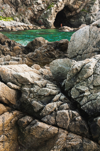 Rocks and grotto on the seashore, cloudy weather at sea, coastline of telyakovsky Bay Primorsky Krai, Russia. photo