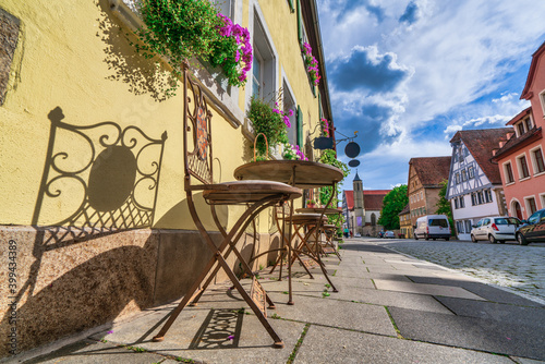 Old table and chairs at spitalgasse street in Rothenburg ob der Tauber. Bavaria, Germany photo