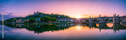 Beautiful sunset panorama of Wurzburg with Marienberg Fortress and reflection river. Germany
