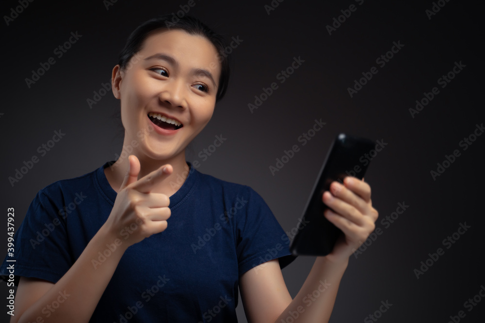 Asian woman happy surprised holding smart phone.