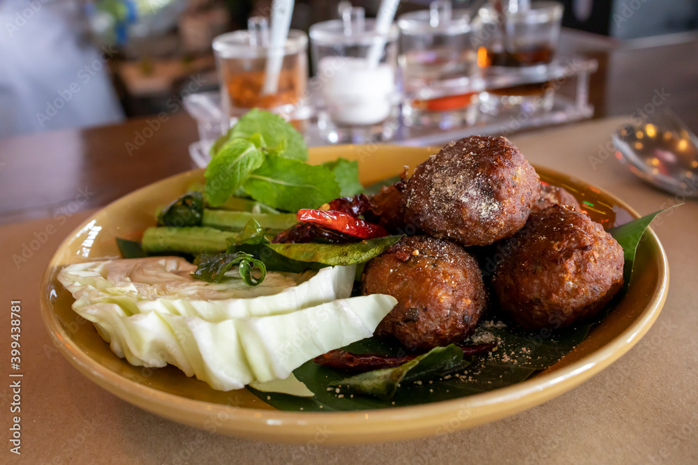 Larb Mood Tod, Thai crispy pork and herb balls, soft focus Larb Mood Tod, Thai crispy pork and herb balls, soft focus