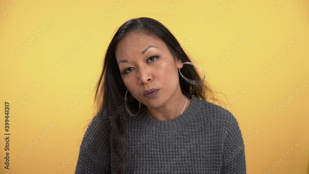 Frustrated woman shakes head and says no agressively.