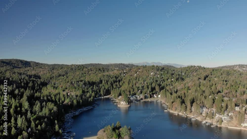 Aerial view overlooking forest, hills, and houses surrounding Lake Arrowhead, sunny, fall day, in California, USA - descending, drone shot Aerial view overlooking forest, hills, and houses surrounding Lake Arrowhead, sunny, fall day, in California, USA - descending, drone shot