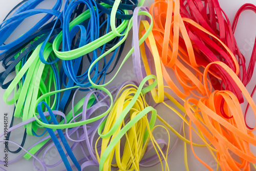 pile of colorful rubber bands on white background. photo