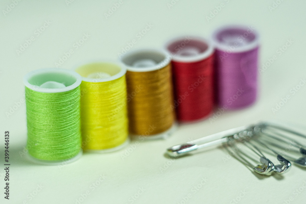 Multicolored coils of thread on a green background. Multicolored coils of thread on a green background.