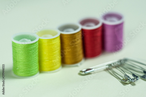 Multicolored coils of thread on a green background.