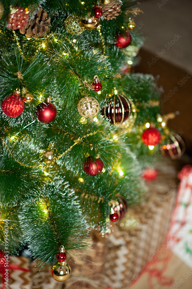 christmas tree in red and gold decorations on a brown background. Gift boxes. Happy Christmas. Side.