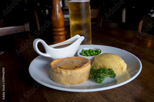 British pie served with potato mach, peas and gravy. 
Pub food