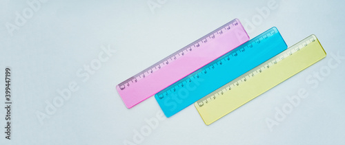 multicolored school rulers on a light background