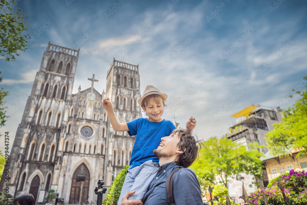 Young dad and son tourists on background of St Joseph's Cathedral in Hanoi. Vietnam reopens after coronavirus quarantine COVID 19 Young dad and son tourists on background of St Joseph's Cathedral in Hanoi. Vietnam reopens after coronavirus quarantine COVID 19