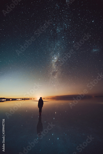 person on the lake under stars and Milky Way 