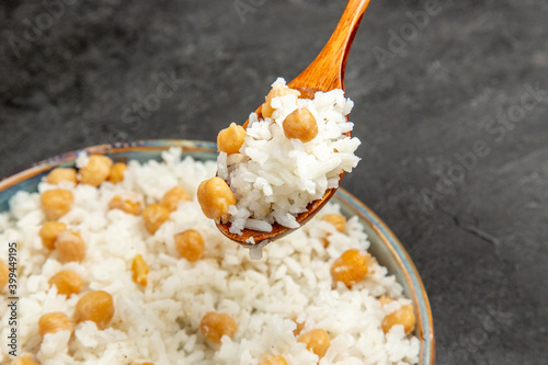 Quick and easy peas and rice meal for dinner with holding a spoon on dark table stock image photo