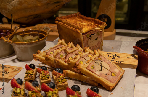 Brunch buffet with liver terrine, Foie Gras berry pistachio canapes, Coppa ham, salami, olives and antipasti