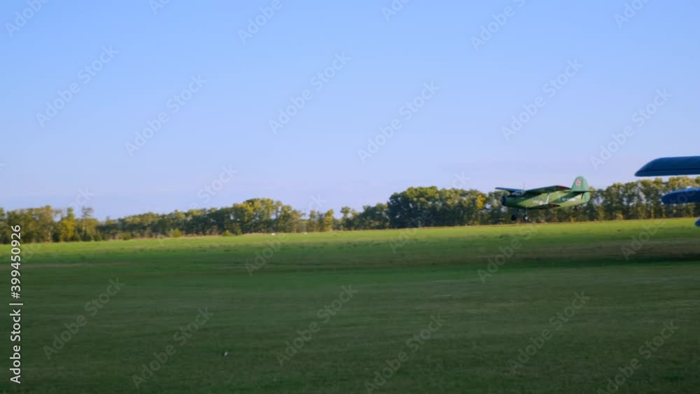 Small Plane Takes Off from Earthen Runway. Small Aviation. Parachuting. Athletes on Board. Endless Fields. Beauty of Nature. Blue sky. Panoramic Shooting. Green Airplane. Slow motion. Small Airfield Small Plane Takes Off from Earthen Runway. Small Aviation. Parachuting. Athletes on Board. Endless Fields. Beauty of Nature. Blue sky. Panoramic Shooting. Green Airplane. Slow motion. Small Airfield