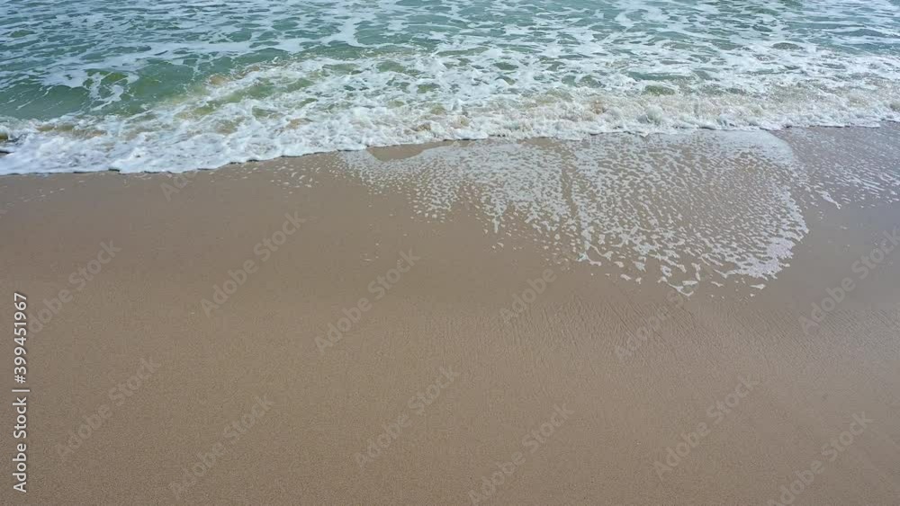 Soft wave with the blue ocean on a sandy beach. Holiday time vacation.
Soft wave with the blue ocean on a sandy beach. Holiday time vacation.
