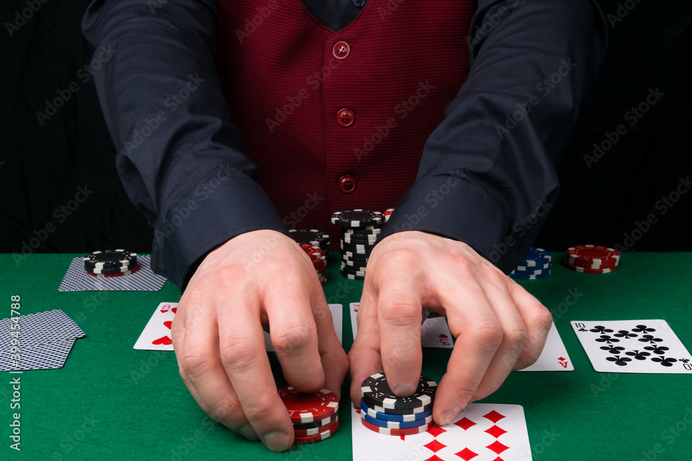 poker game, dealer gives out winnings in chips, close-up of hands poker game, dealer gives out winnings in chips, close-up of hands
