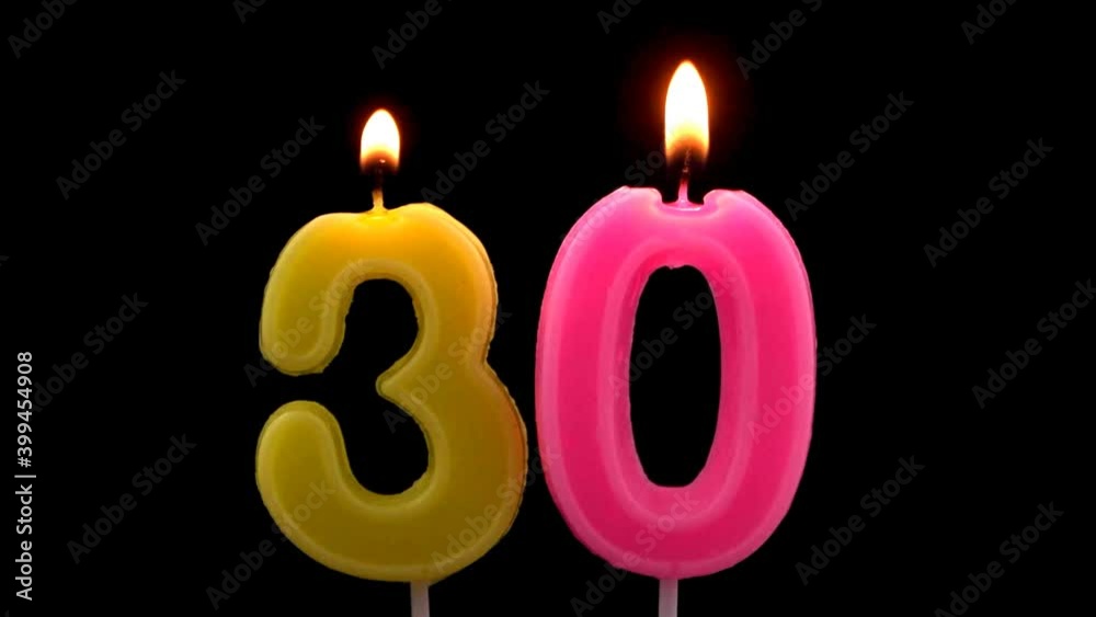 Burning birthday candles isolated on black background, number 30 Burning birthday candles isolated on black background, number 30