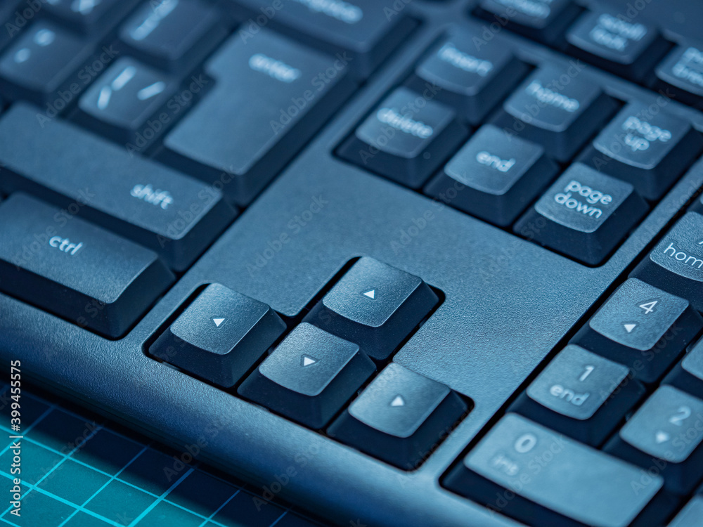 Arrow keys. Closeup shot of computer keyboard. Black computer keyboard close-up. Up, down, right, and left keys. Working on a PC. Peripheral computer equipment. Arrow keys. Closeup shot of computer keyboard. Black computer keyboard close-up. Up, down, right, and left keys. Working on a PC. Peripheral computer equipment.