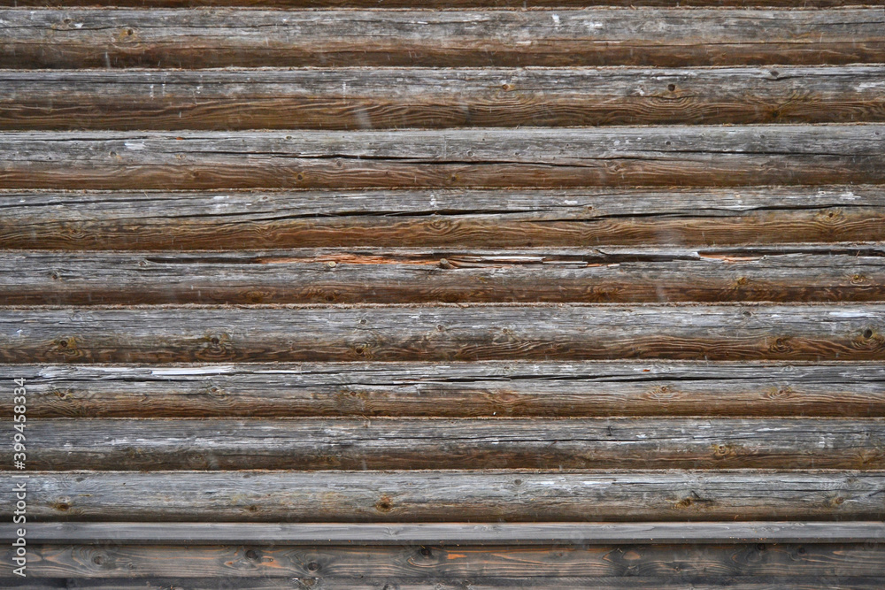 Natural dark background pattern of a log without bark and with a natural stain finish. Natural dark background pattern of a log without bark and with a natural stain finish.