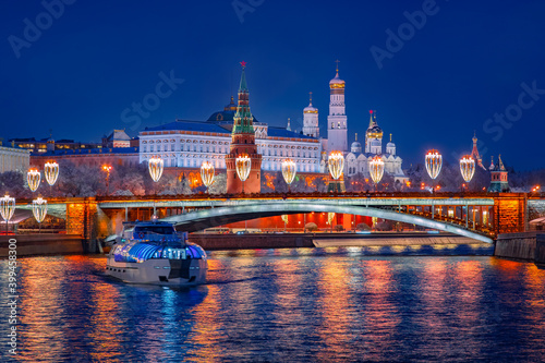 Motor ship in center of Moscow. Christmas in Russia. Panorama of New Year's Kremlin embankment. Great Kremlin Palace on a winter night. Water travel on night before Christmas. Guided tours in Moscow.