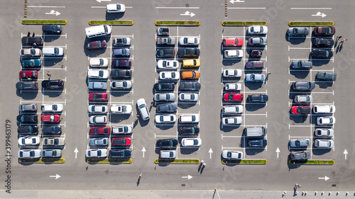 Parking lot with many cars aerial top drone view from above, city transportation and urban concept

