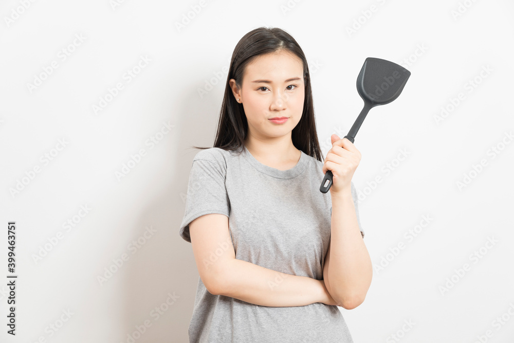 Asian woman holding ladle ready for cooking isolated on white background. Asian woman holding ladle ready for cooking isolated on white background.
