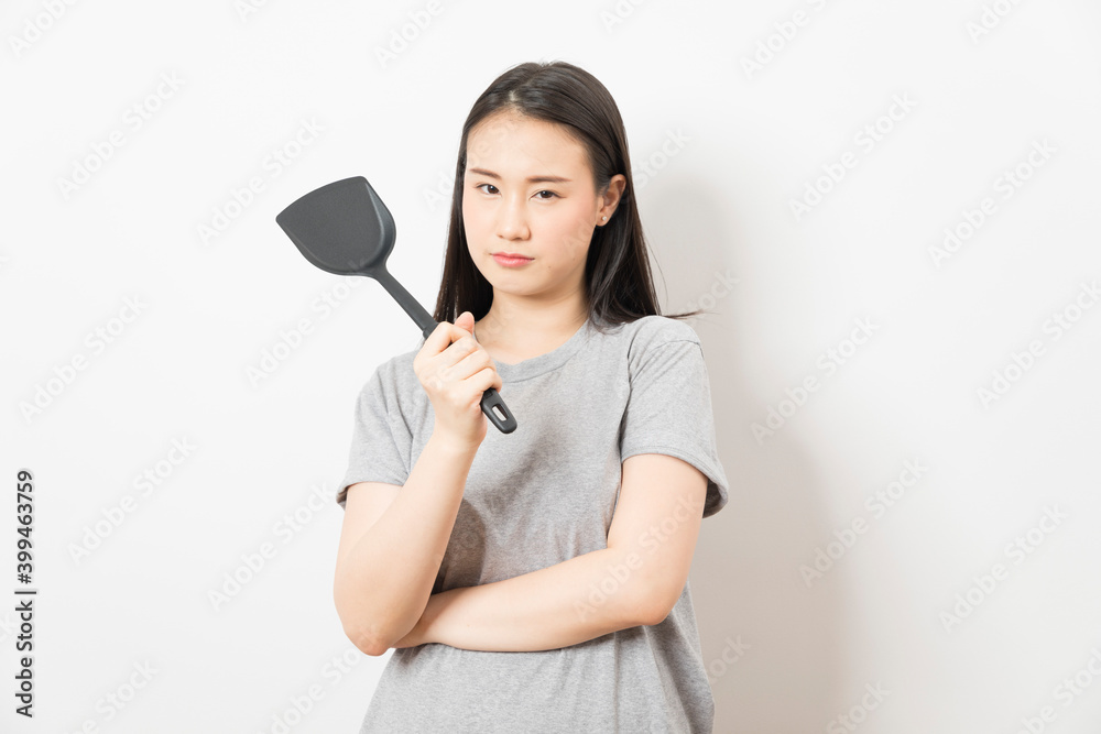 Asian woman holding ladle ready for cooking isolated on white background. Asian woman holding ladle ready for cooking isolated on white background.