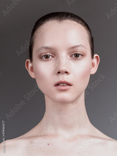 Beauty young woman portrait. Beautiful model girl with perfect fresh clean skin. Youth and skin care concept. Nude makeup