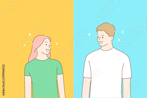 Friendship, positive emotion, young happy people concept. Smiling young man and woman looking at each other and feeling cheerful and excited over blue and yellow background 