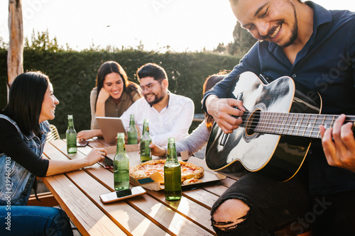 Sticker Mexican friends drinking beer on the terrace and latin man playin a guitar in Me