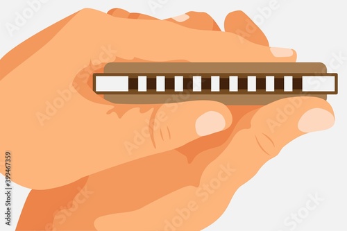 Hands holding a brown harmonica