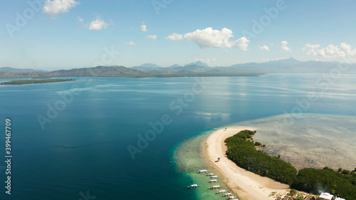 Island with sandy beach in the honda bay top view. Tropical island and coral reef with tourists. starfish island. Summer and travel vacation concept, Philippines, Palawan