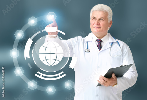 Mature male doctor using vi...