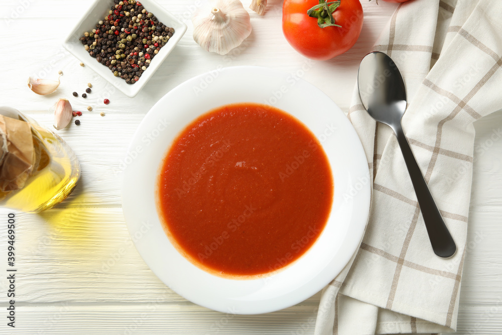 Concept of tasty dinner with tomato soup on wooden background Concept of tasty dinner with tomato soup on wooden background