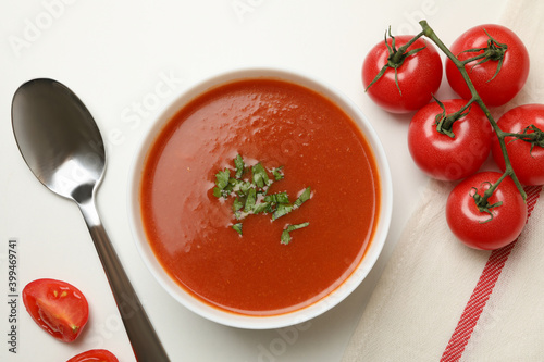 Concept of tasty food with tomato soup on white background