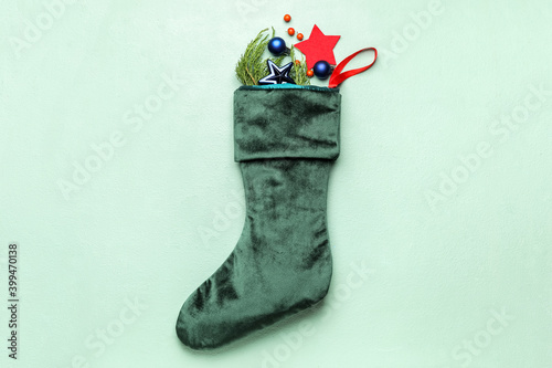 Composition with Christmas sock on color background
