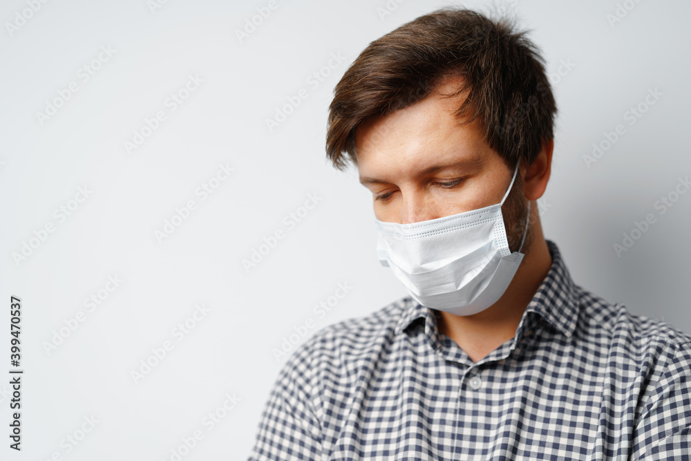 Man wearing hygienic mask against grey background Man wearing hygienic mask against grey background