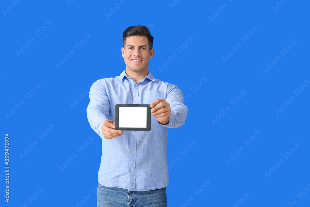 Young man with e-reader on color background Young man with e-reader on color background