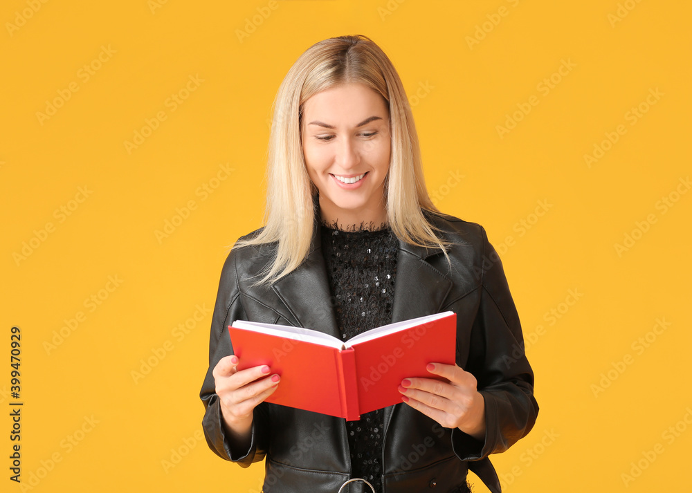 Beautiful young woman reading book on color background Beautiful young woman reading book on color background