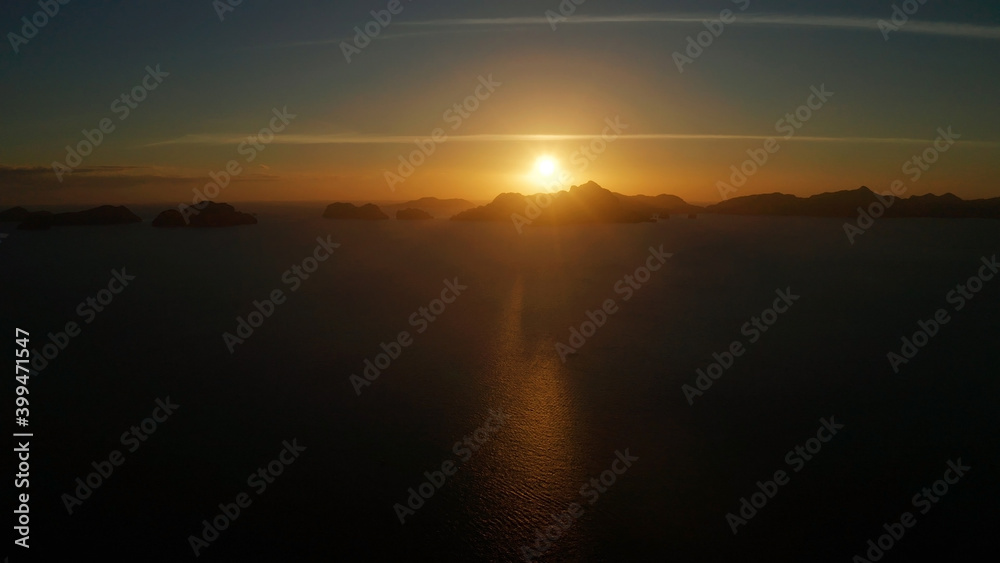 aerial view tropical sunset over the sea background of mountains. El nido, Philippines, Palawan. seascape with tropical islands at sunset time. Summer and travel vacation concept