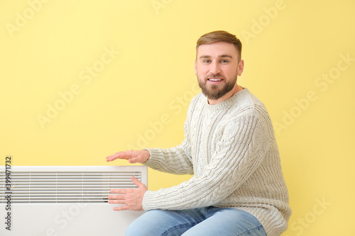 Young man near electric hea...