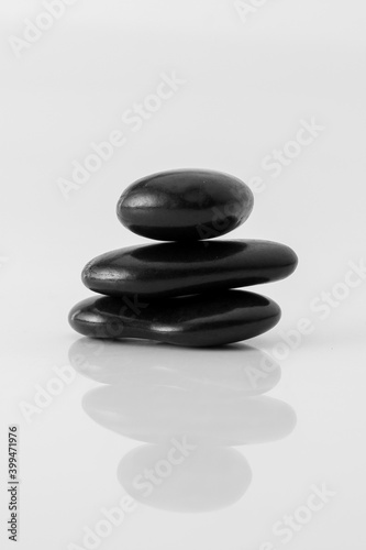  stacked black stones on white background