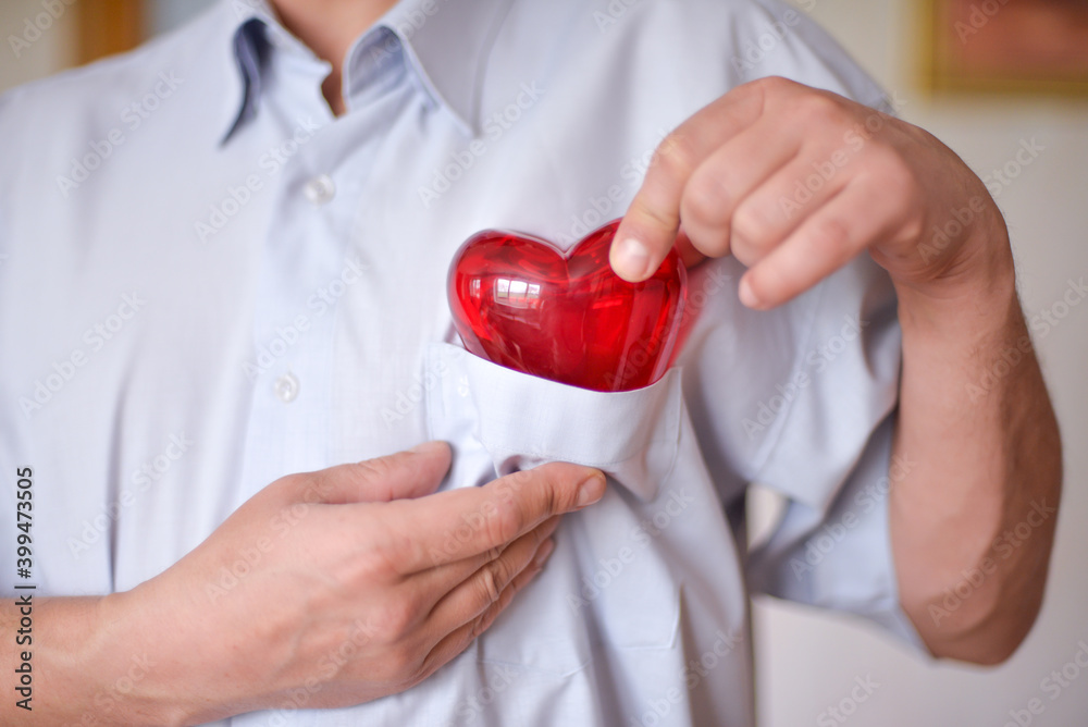 a man holds a heart in his hands as a symbol of care, love, happiness, and health a man holds a heart in his hands as a symbol of care, love, happiness, and health
