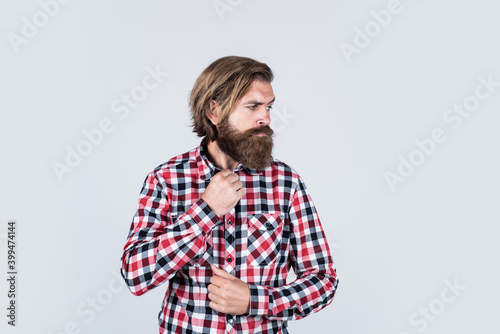 handsome confident man has perfect hairstyle. bearded man in checkered shirt. male beauty concept. Portrait of bearded hipster. guy with long lush beard and mustache on face