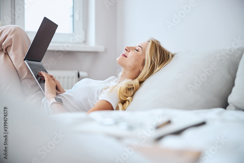 Relaxed blonde woman enjoying the silence at home