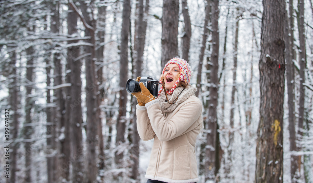 Woman photographer with professional camera. Winter hobby. Enjoy enchanting paleness and freezing atmosphere of winter. Taking stunning winter photos. Enjoy beauty of snow scenery through photos Woman photographer with professional camera. Winter hobby. Enjoy enchanting paleness and freezing atmosphere of winter. Taking stunning winter photos. Enjoy beauty of snow scenery through photos