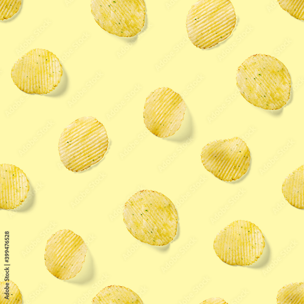 Seamless pattern made from Potato chips on yellow background flat lay. potato snack chips isolated Fast food banner. Seamless pattern made from Potato chips on yellow background flat lay. potato snack chips isolated Fast food banner.